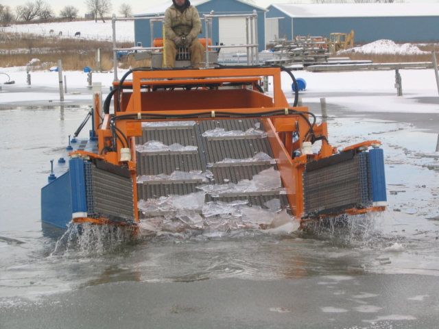 MC 202 picking up winter ice from a marina