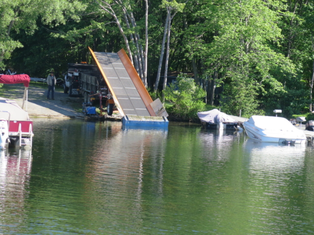 Alphaboats Shore Conveyor ready to load aquatic weeds from harvester